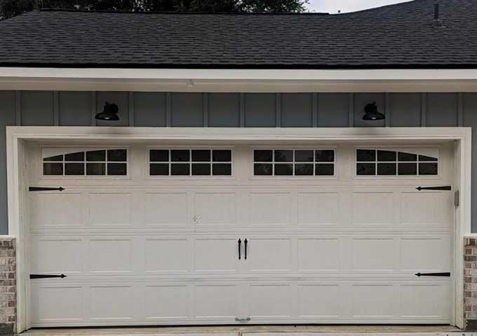 White carriage-house garage door after repair