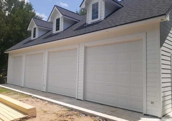 Row of four white garage doors